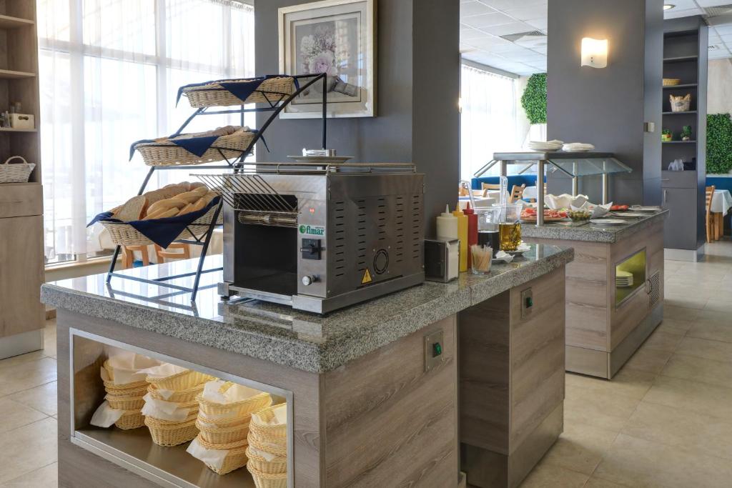 a kitchen with a counter with cupcakes on it at Paraiso Theopolis - All Inclusive in Obzor