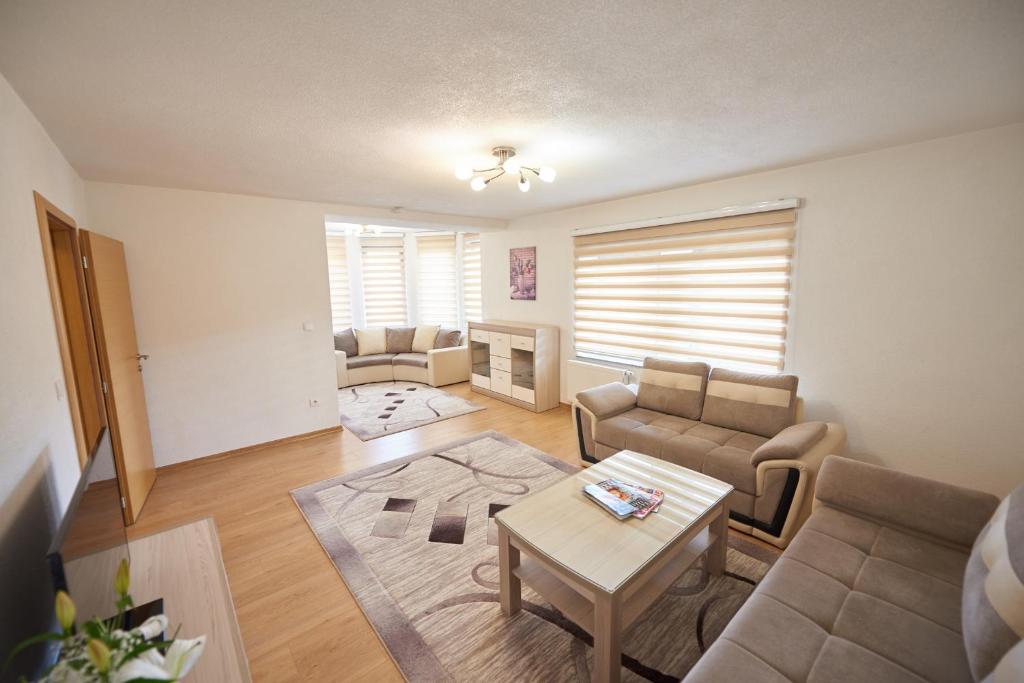 a living room with a couch and a table at Grand Apartments-For Groups in Sarajevo
