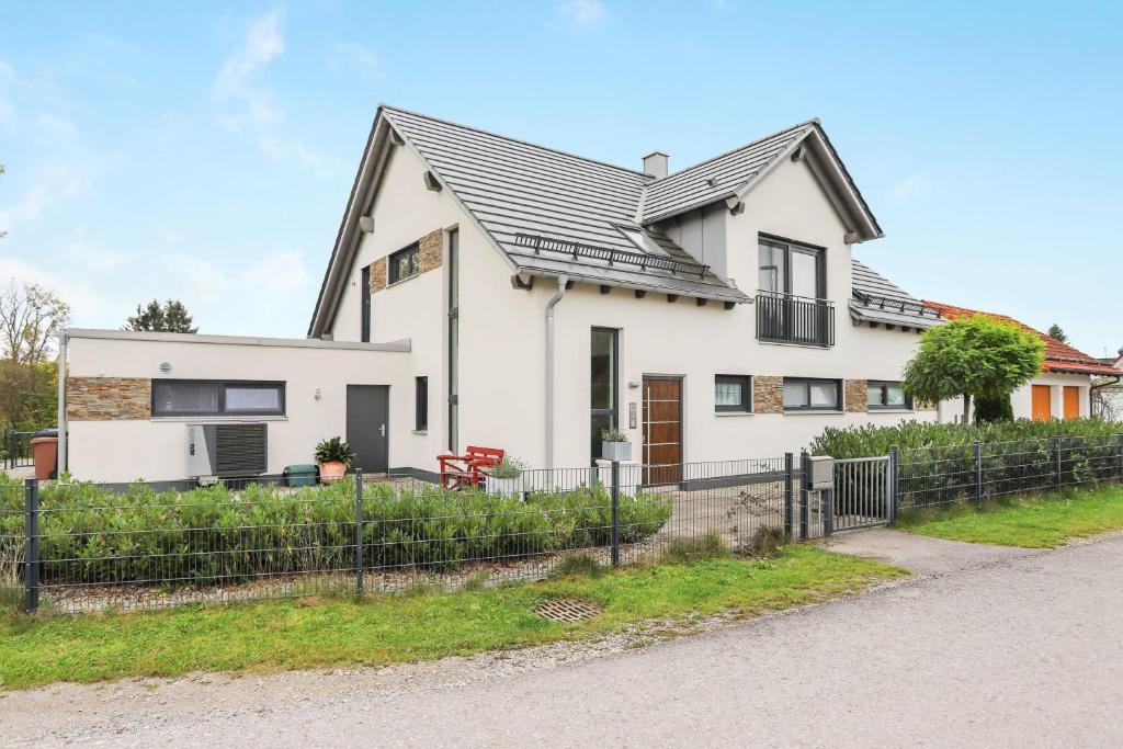 a white house with a black roof at Ferienwohnung Familie Arnhofer in Waal