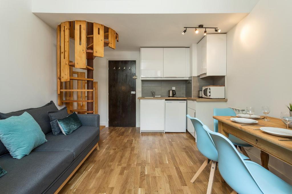 a living room and kitchen with a couch and a table at Apartment Iris 4 in Chamonix-Mont-Blanc