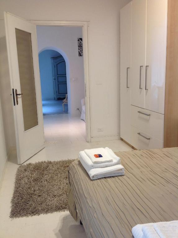 a bedroom with a bed with two towels on it at Madama Suite in Turin