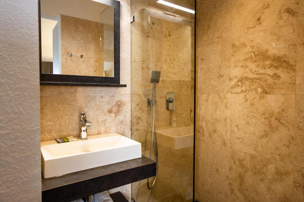 a bathroom with a sink and a mirror at Centr'Hotel in Marigot