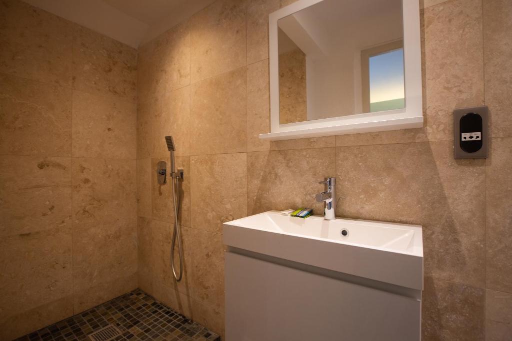 a bathroom with a sink and a shower at Centr'Hotel in Marigot