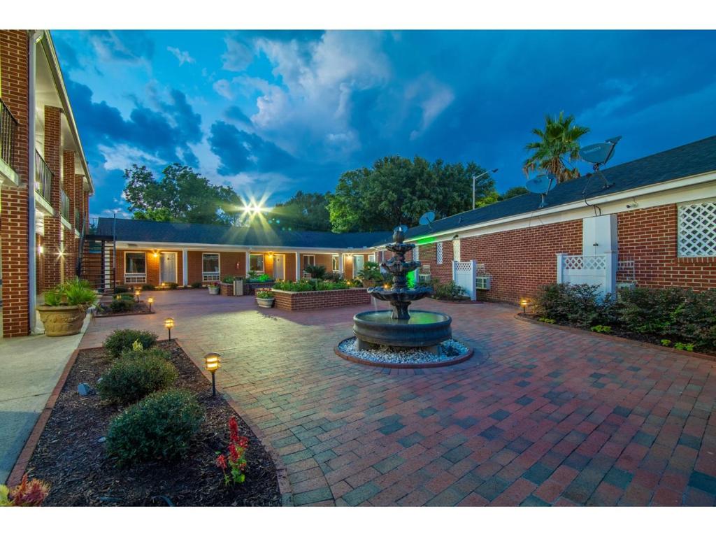 a courtyard with a fountain in the middle of a building at Winton Inn & Suites in Barnwell