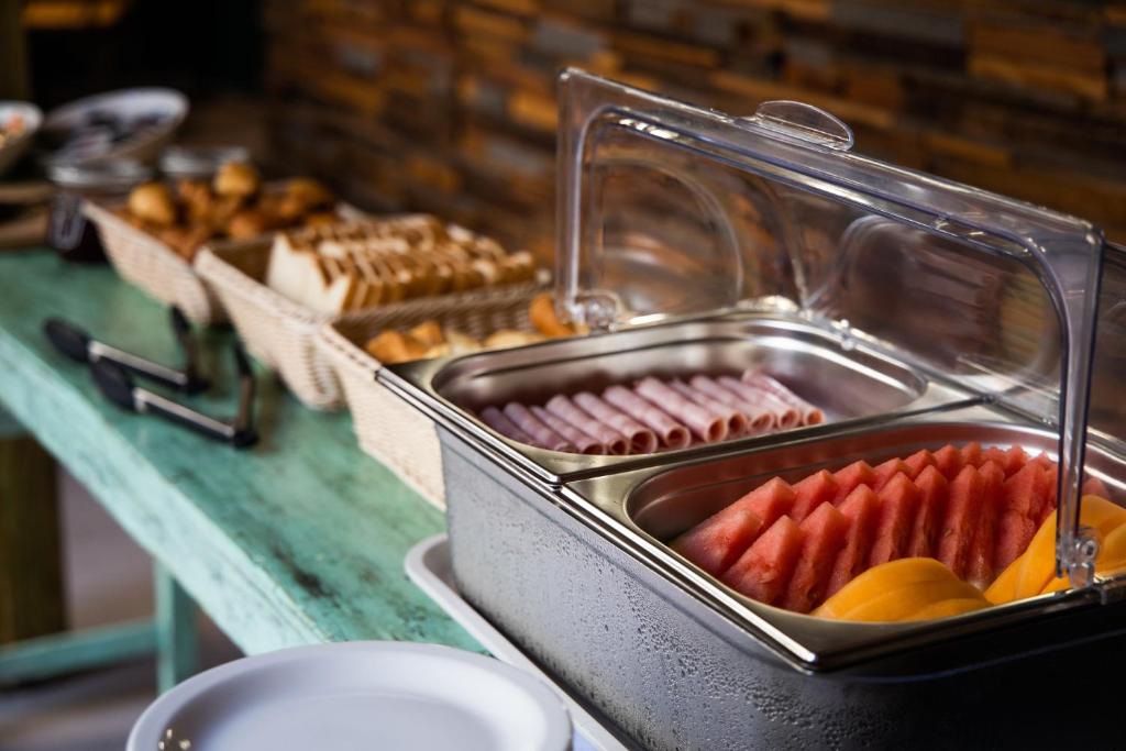 a buffet with a bunch of different types of food at Centr'Hotel in Marigot