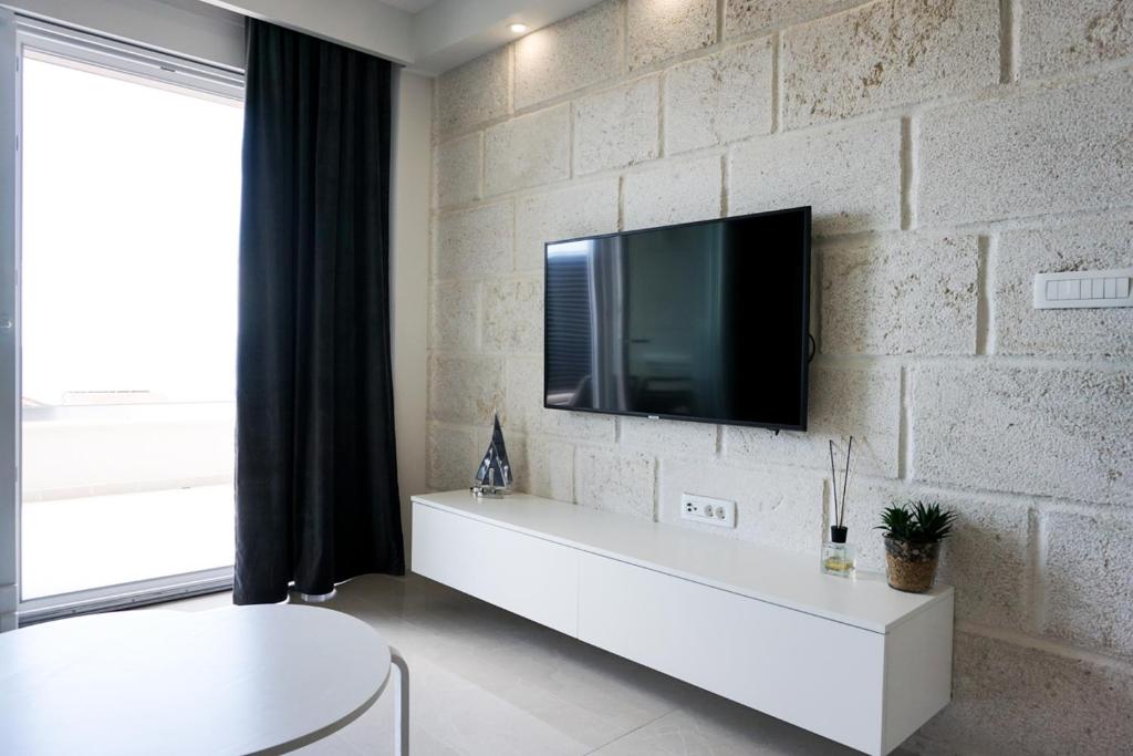Televízia a/alebo spoločenská miestnosť v ubytovaní SoL Rooftop Apartments