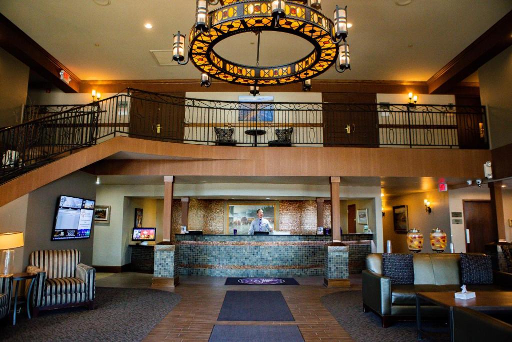 a lobby of a hotel with a large chandelier at Heritage Inn in Great Falls