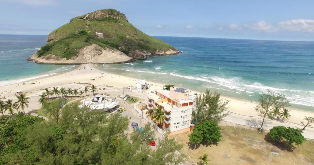 a view of a beach with a building and the ocean at KS Beach Hotel in Rio de Janeiro