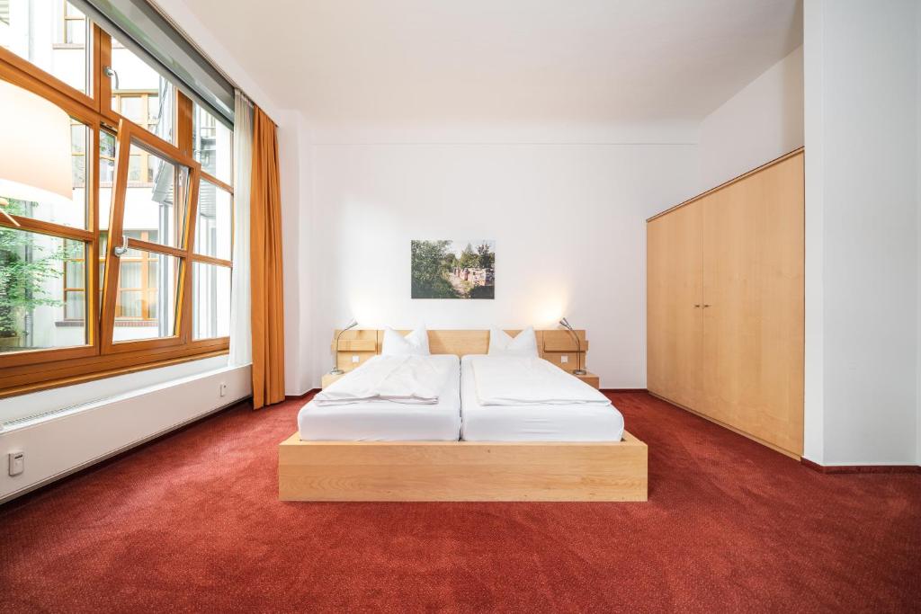 a bedroom with a bed and a large window at Hotel 26 in Berlin