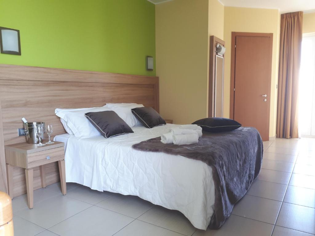 Postel nebo postele na pokoji v ubytování Hotel La Ninfea