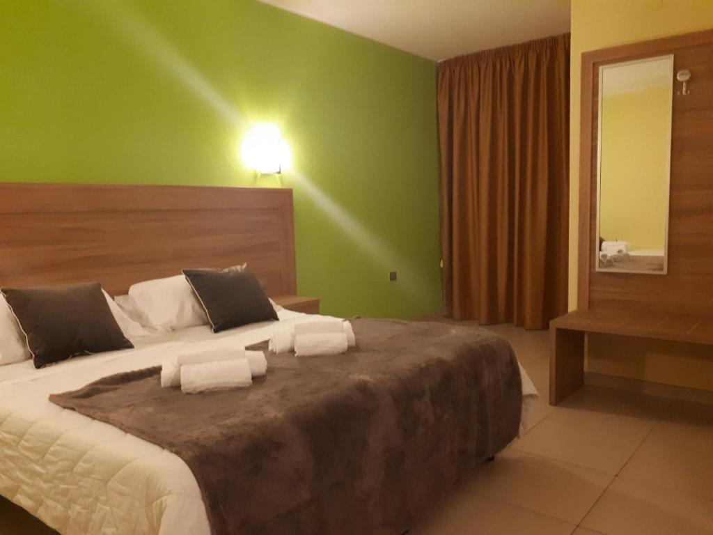 Postel nebo postele na pokoji v ubytování Hotel La Ninfea