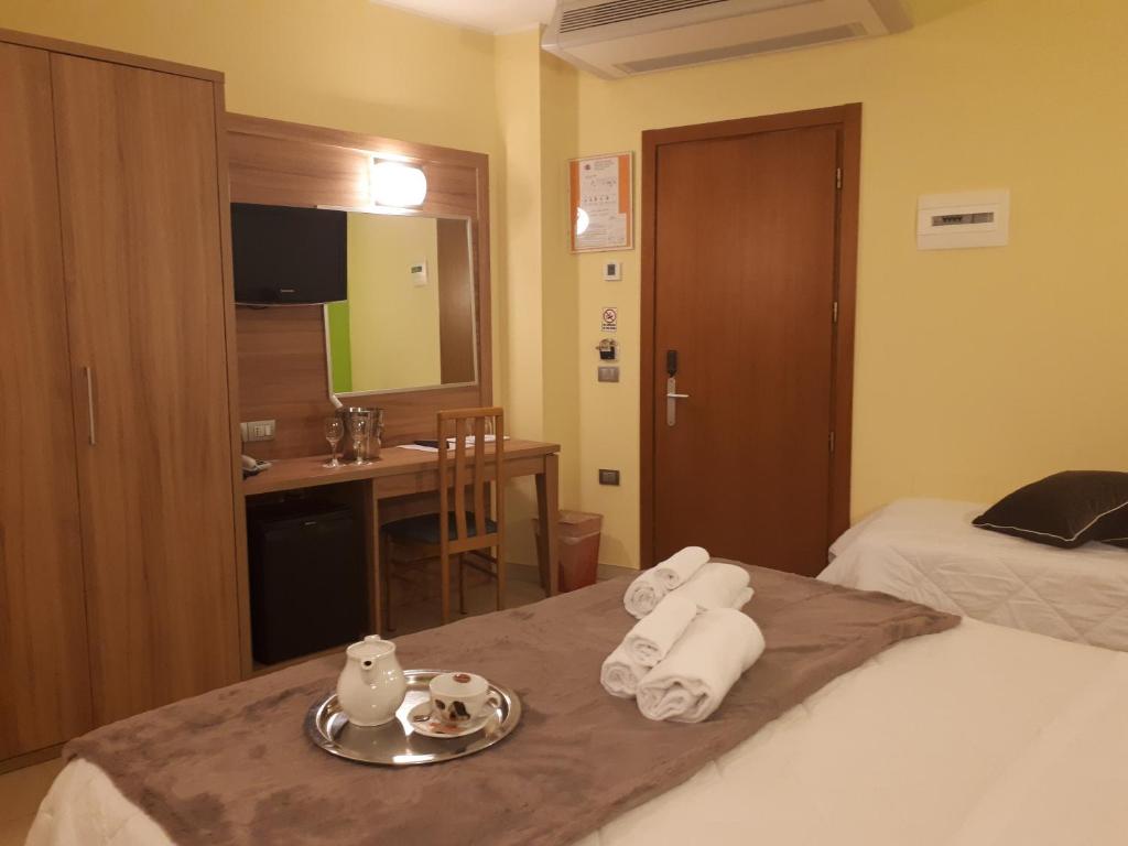 Postel nebo postele na pokoji v ubytování Hotel La Ninfea