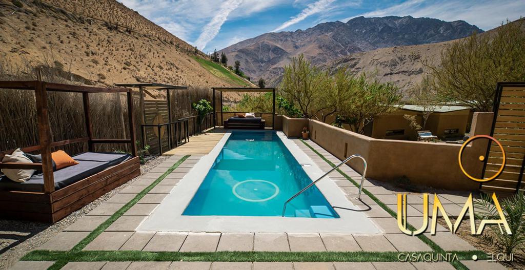 a swimming pool with a view of a mountain at UMA Hotel in Pisco Elqui