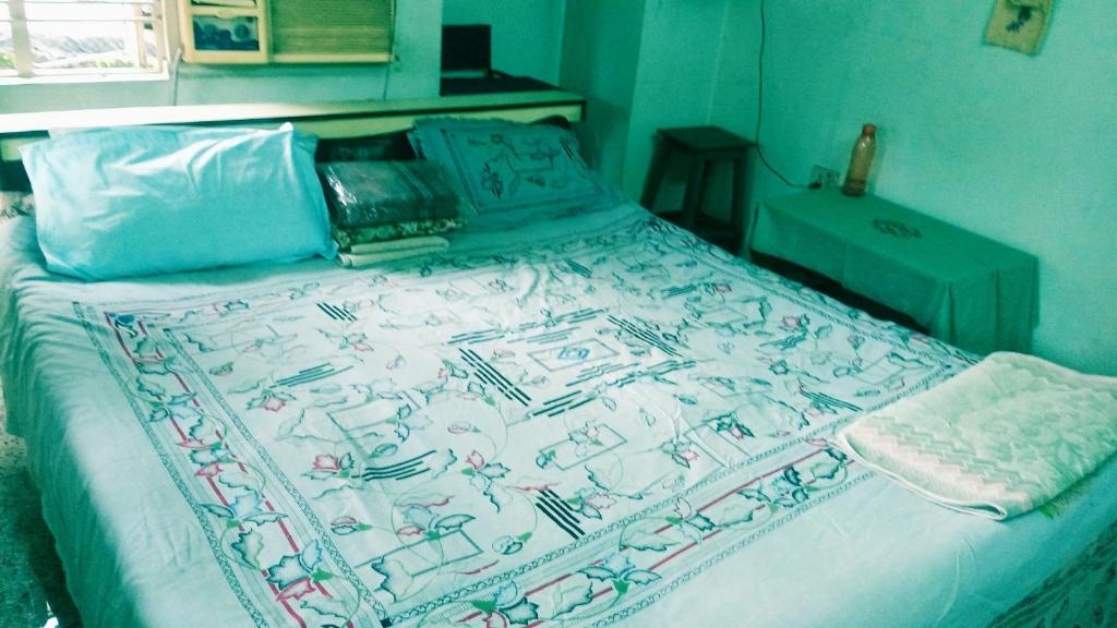 a bed in a bedroom with a blanket on it at Hospdigisy-Double bed private room in Howrah
