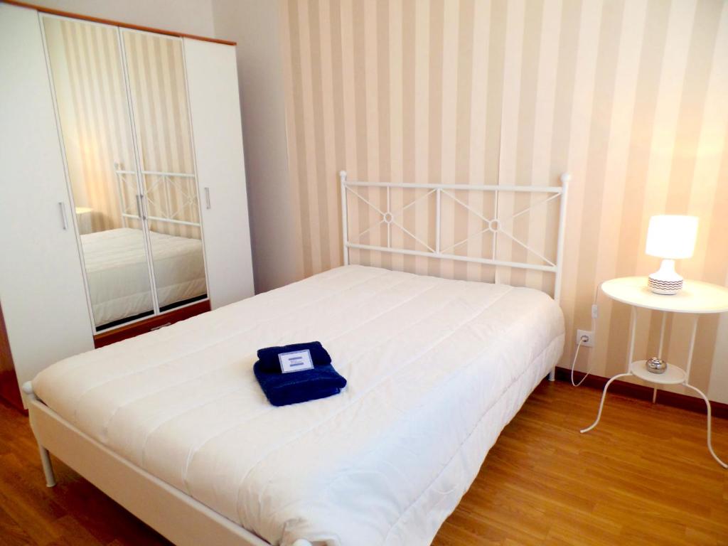 a bedroom with a bed with a blue box on it at Pátio das Cavadas Apartment in Rio Tinto