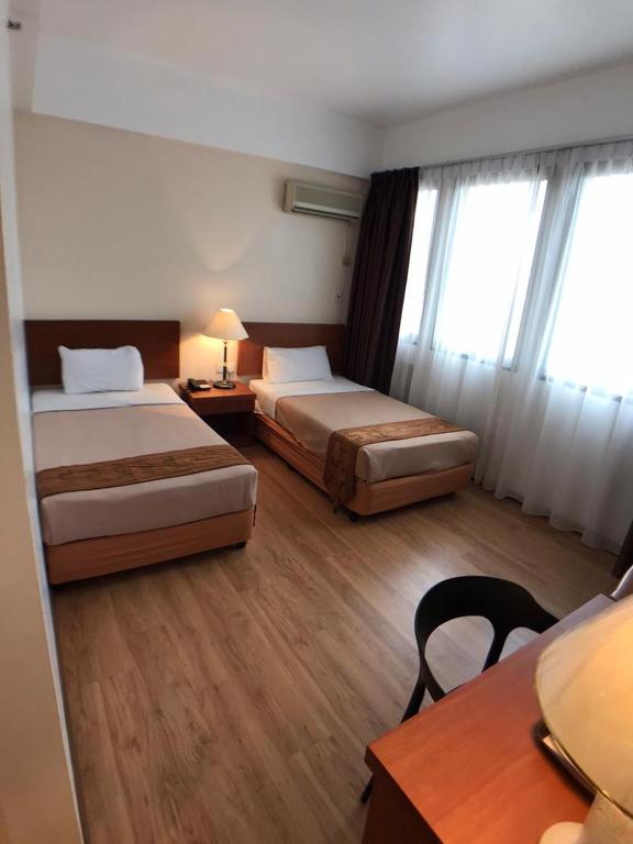 Postel nebo postele na pokoji v ubytování Kawan Hotel