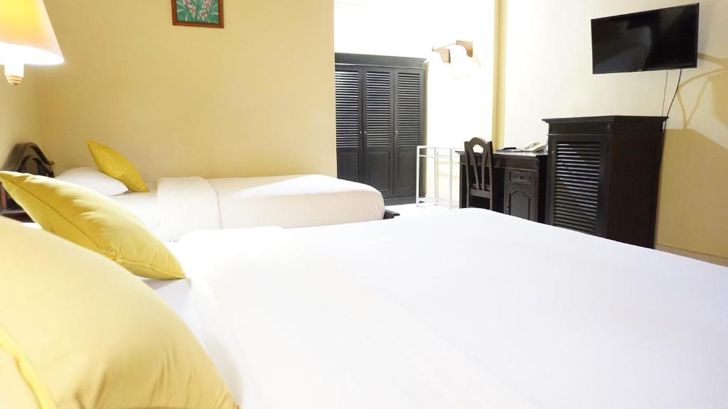 Postel nebo postele na pokoji v ubytování Masainn Hotel Kuta