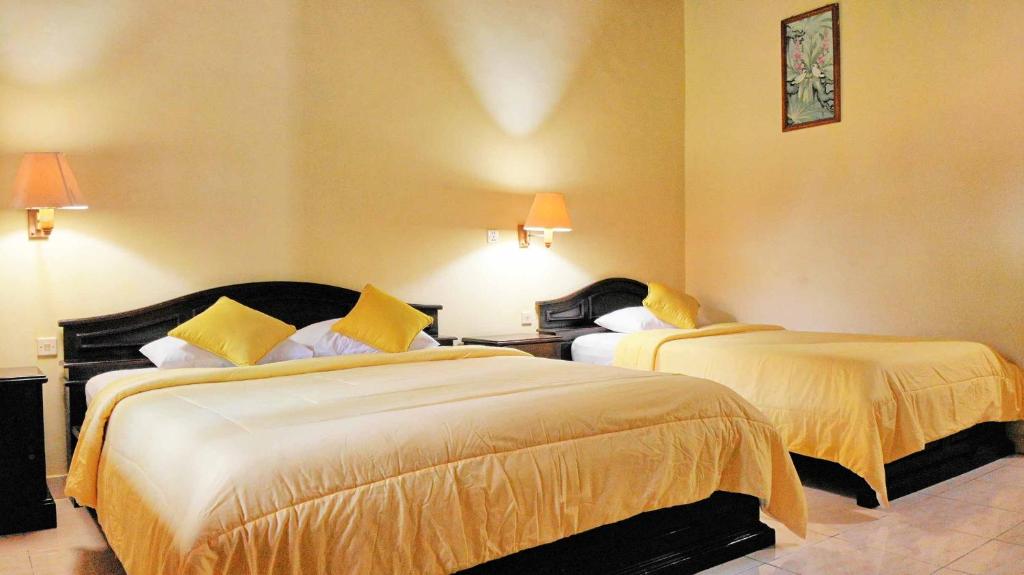 Postel nebo postele na pokoji v ubytování Masainn Hotel Kuta