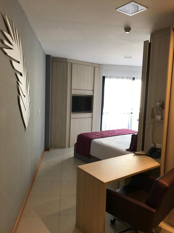 Postel nebo postele na pokoji v ubytování Boulevard Residencial