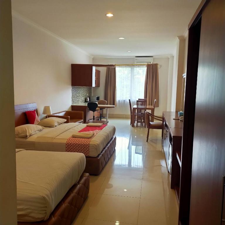 Postel nebo postele na pokoji v ubytování HOTEL & WISMA BINTANG JADAYAT