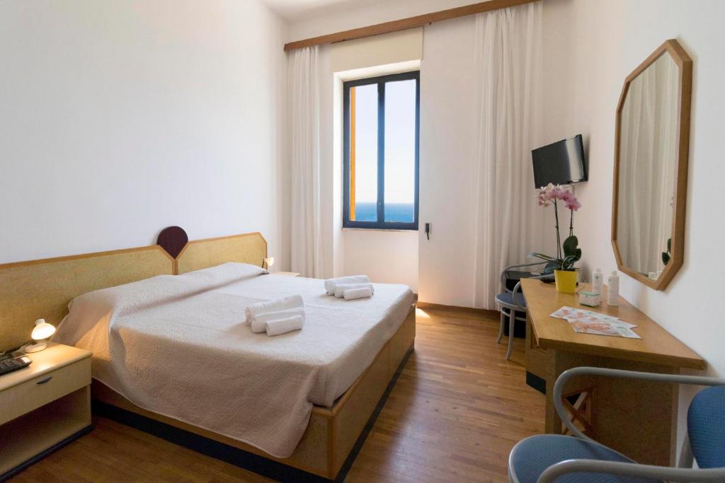 Postel nebo postele na pokoji v ubytování Albergo Palazzo