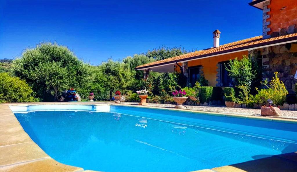 a swimming pool in front of a house at Casa vacanza centro Sardegna in Sorgono