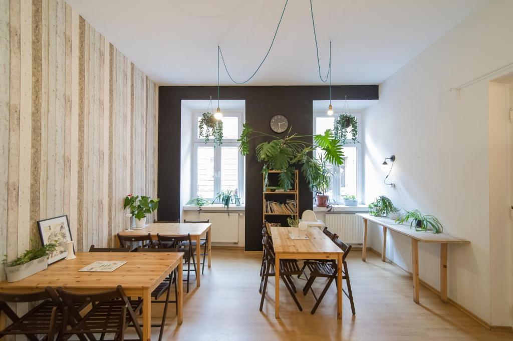 a dining room with wooden tables and chairs at Hostel Cinnamon in Krakow