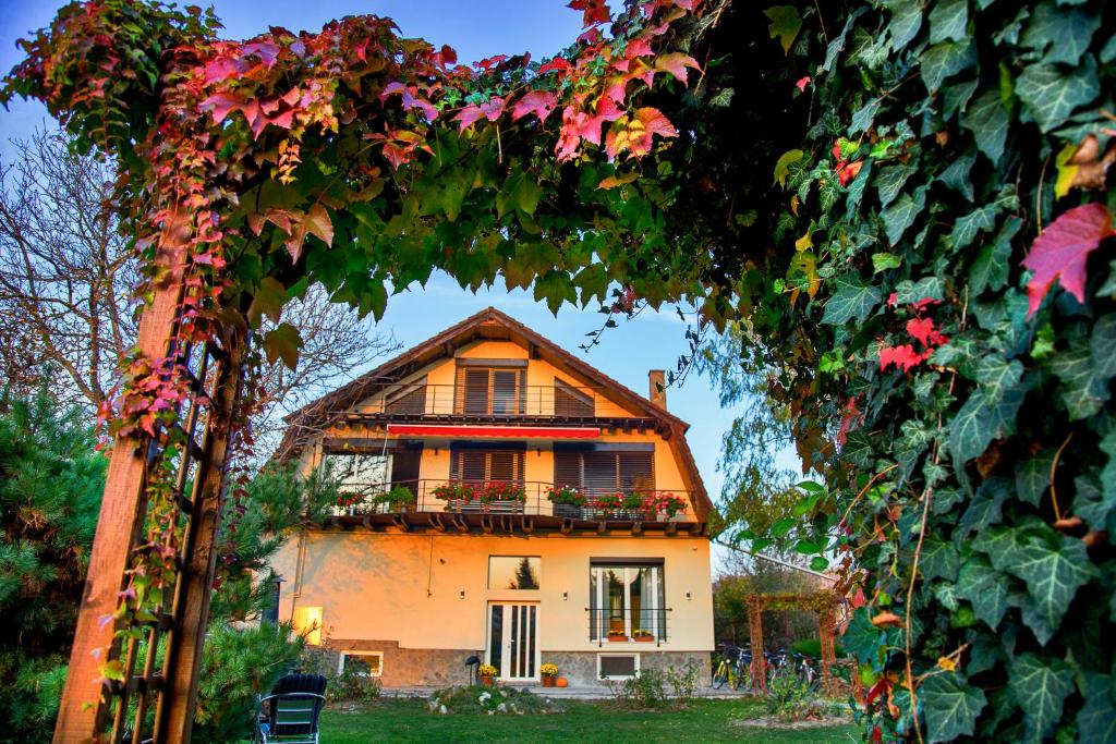 a house with a balcony and a bunch of flowers at Villa Umberti in Sibiu
