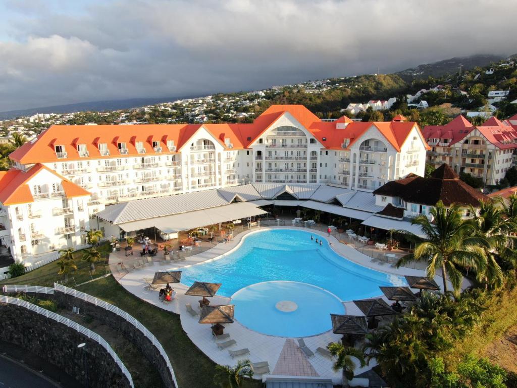 an aerial view of a resort with a swimming pool at Hôtel Exsel Créolia in Saint-Denis