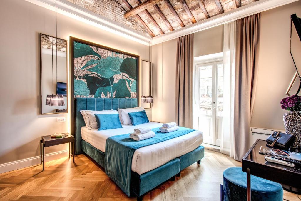 a bedroom with a bed and a painting on the wall at Hotel 55 Fifty-Five - Maison d'Art Collection in Rome