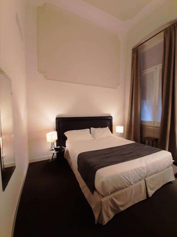 A bed or beds in a room at Hotel Palazzo Vannoni