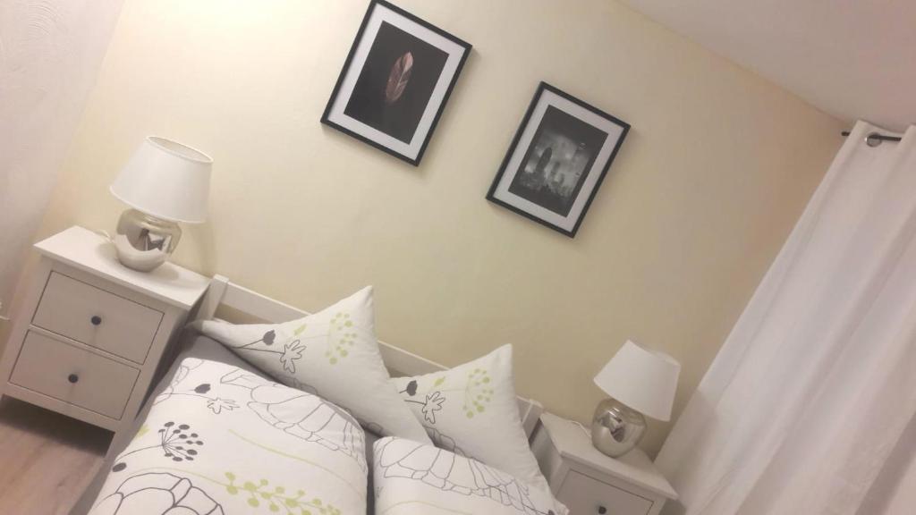 a bedroom with a bed and two pictures on the wall at Ferien im Schwarzwald in Seebach