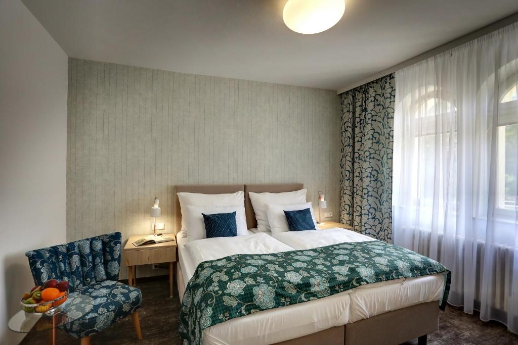 Postel nebo postele na pokoji v ubytování ASTORIA Hotel & Medical Spa