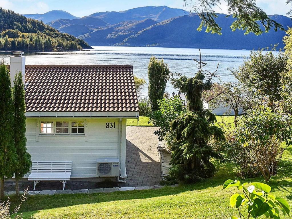 a white house with a view of a lake at 6 person holiday home in Volda in Ålesund