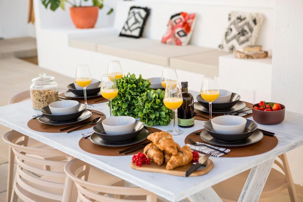 a white table with food and glasses of wine at Sea'Ya Thoughtful Stays - Villas in Cascais
