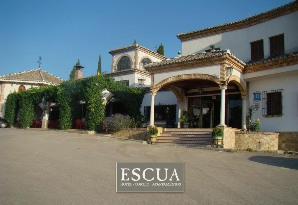 a large white house with an archway in front of it at Escua in Archidona