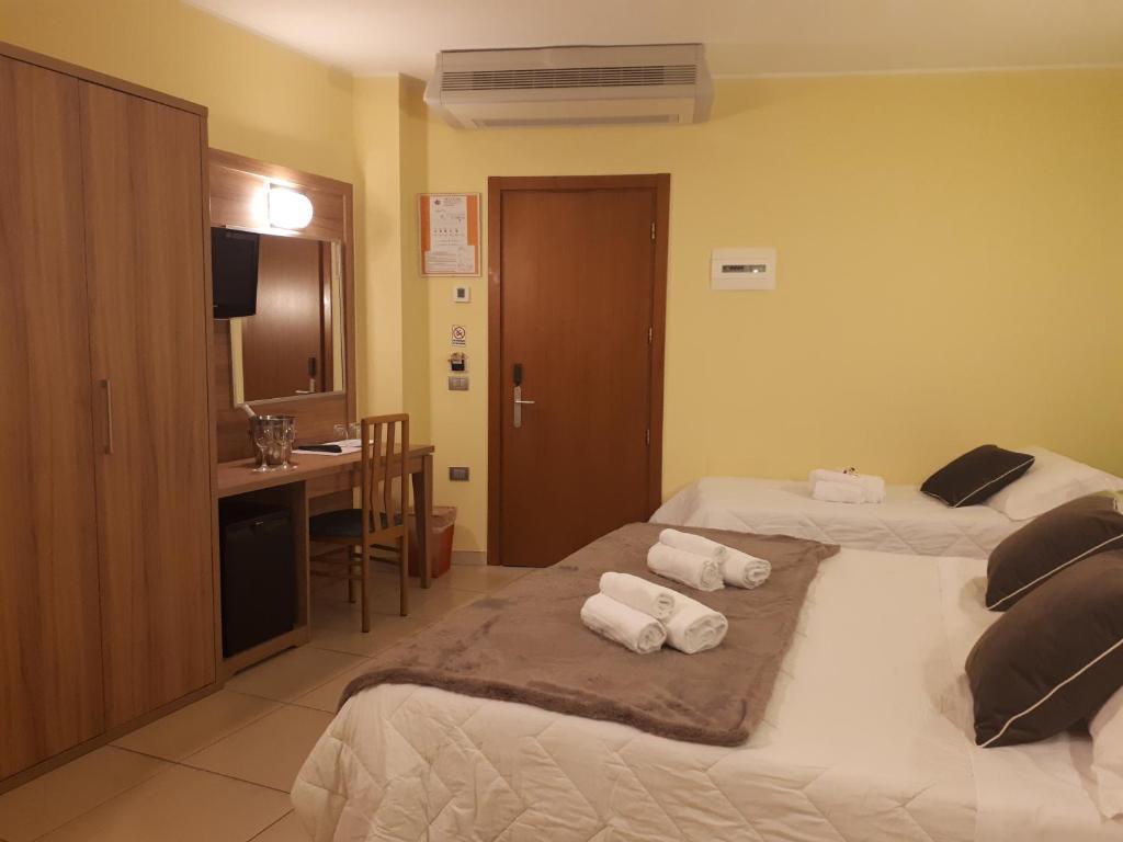 Postel nebo postele na pokoji v ubytování Hotel La Ninfea