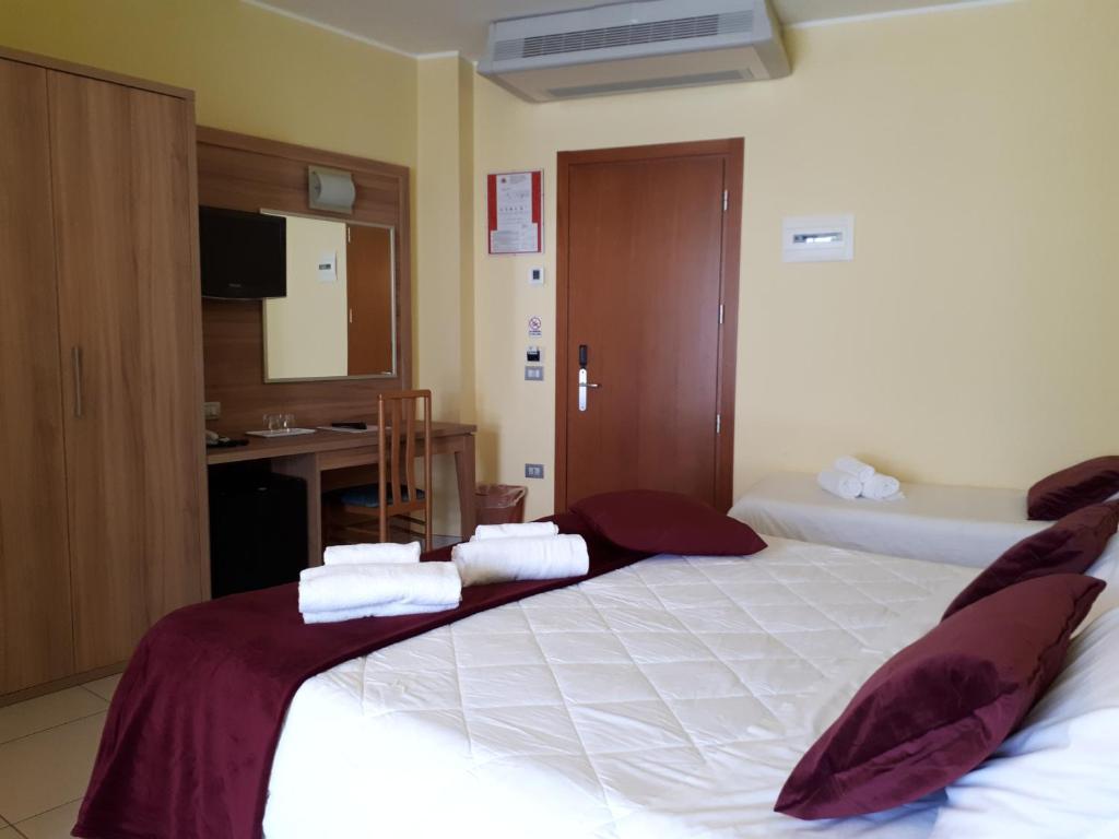 Postel nebo postele na pokoji v ubytování Hotel La Ninfea