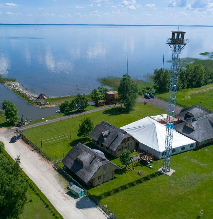 an aerial view of a house with a tent next to the water at Järveveere Puhkekeskus in Valma