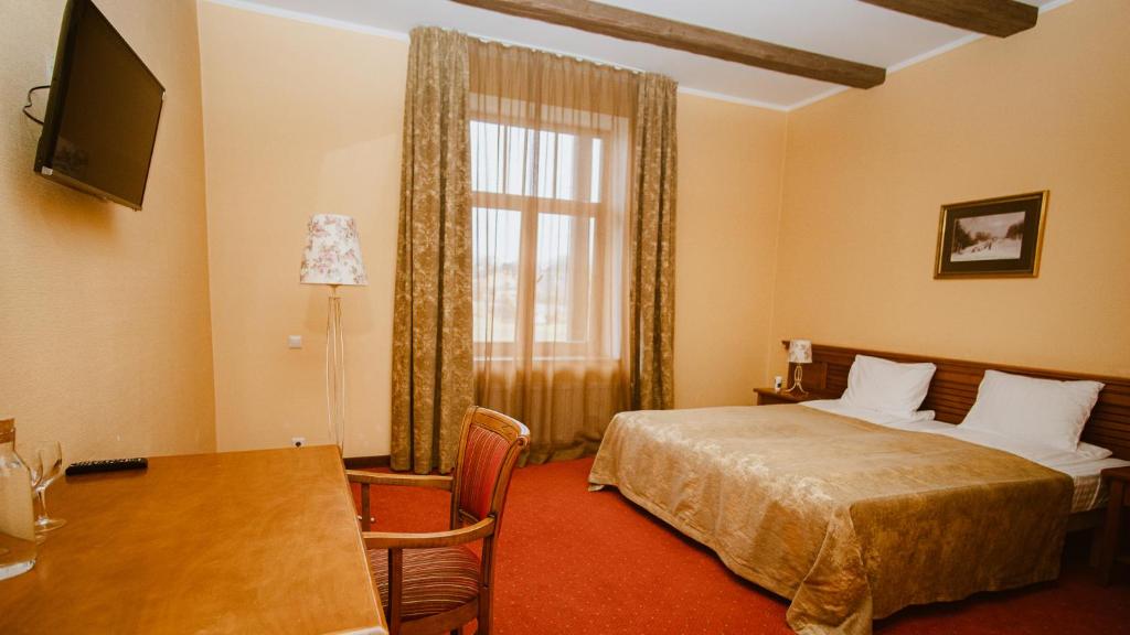 Postel nebo postele na pokoji v ubytování Kaķītis hotel & spa