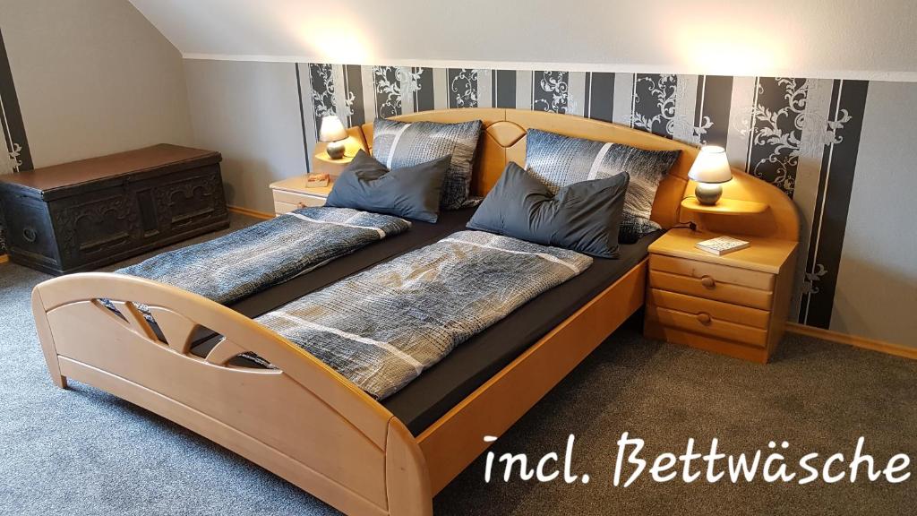 a bedroom with two beds with blue pillows at Kansteinblick Weserbergland in Salzhemmendorf
