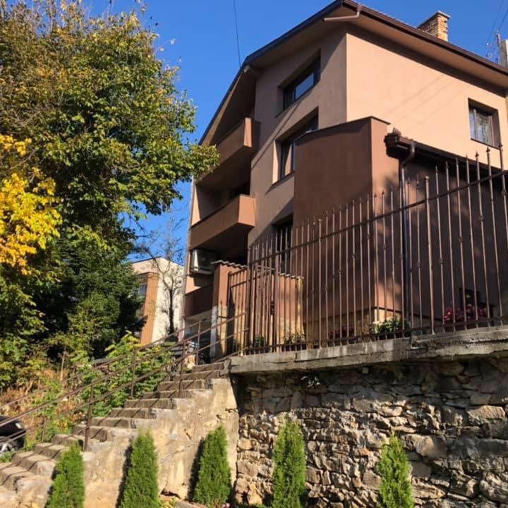 a building with a fence on top of a stone wall at Вила Мечта in Starozagorski Bani