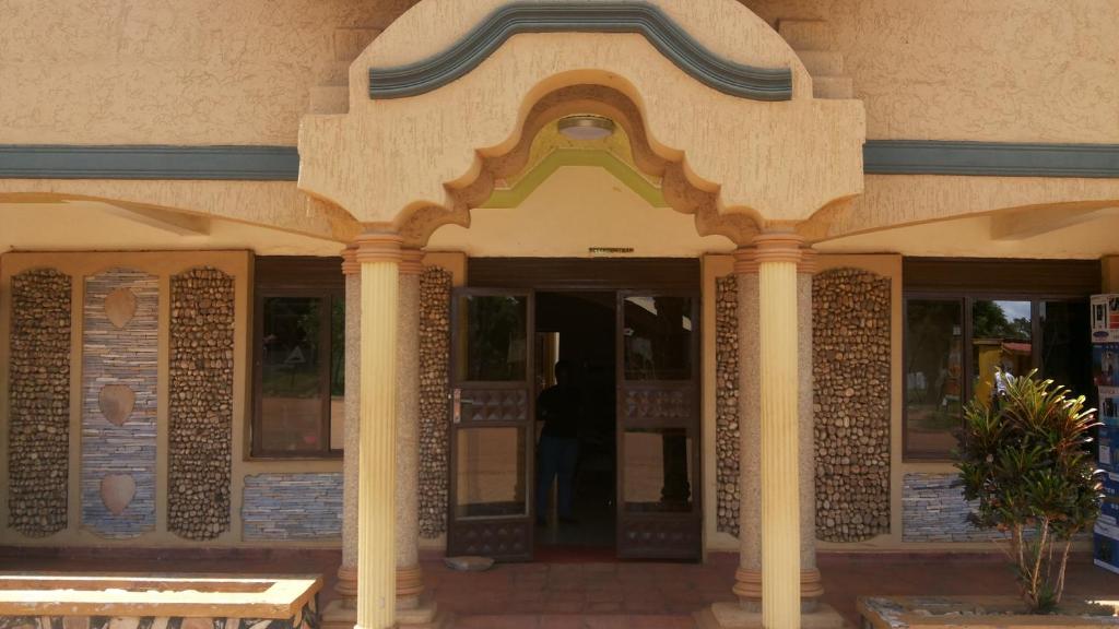 an entrance to a building with columns at Hotel Bucolic Heritage in Adjumani