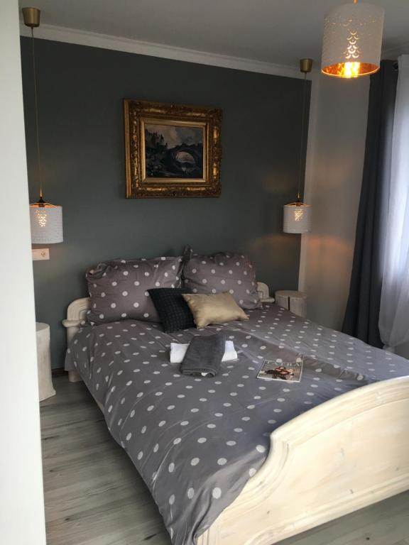 a bed with polka dot sheets in a bedroom at Apartamenty i pokoje u Staszelów in Poronin