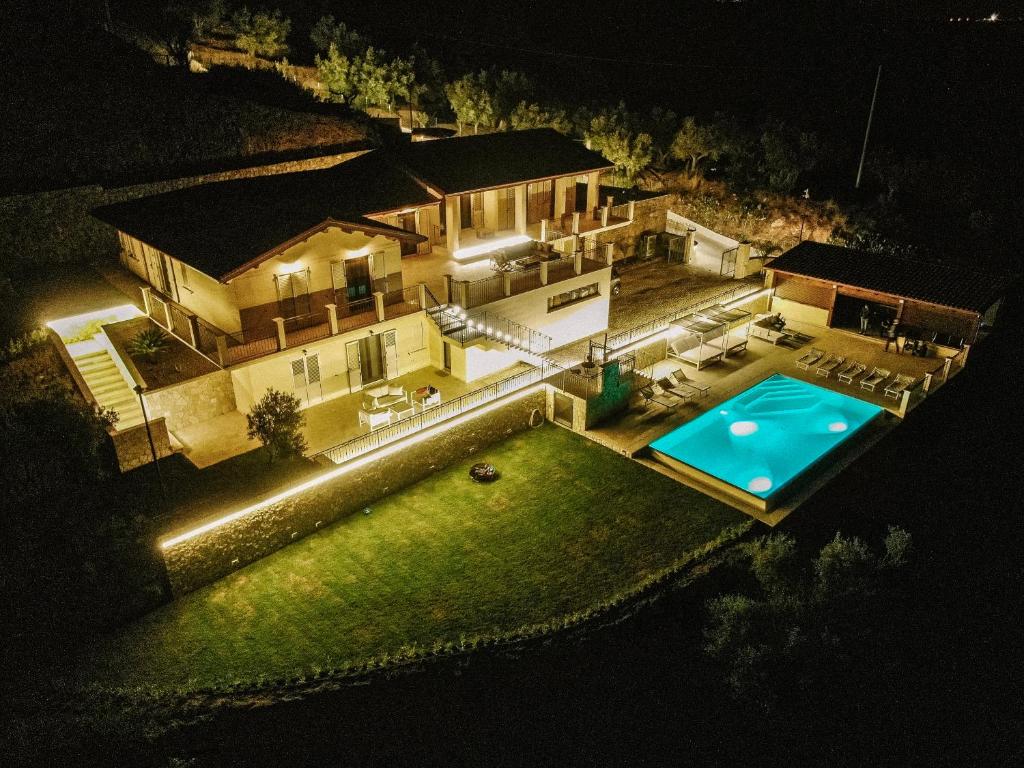 an aerial view of a house with a swimming pool at night at Villa le Fontanelle in Gasperina