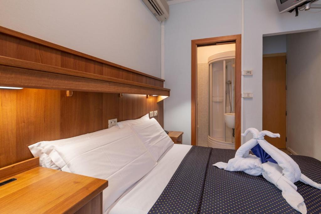 Postel nebo postele na pokoji v ubytování Hotel Mimosa