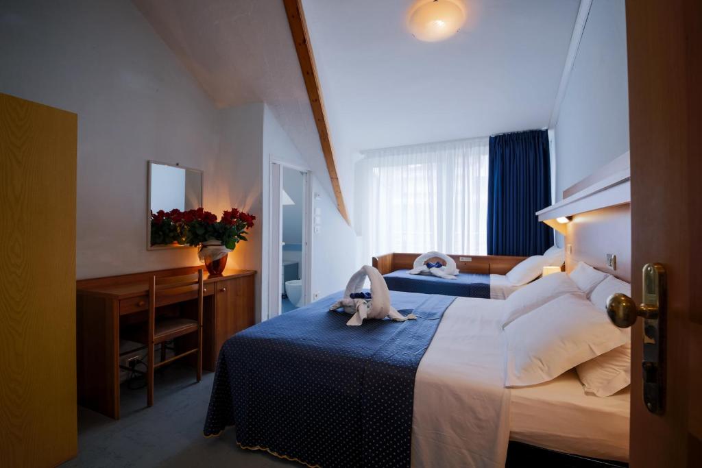 Postel nebo postele na pokoji v ubytování Hotel Mimosa