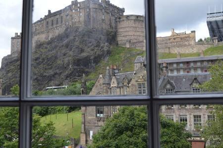 a view of a castle from a window at castle Apartment 1 in Edinburgh