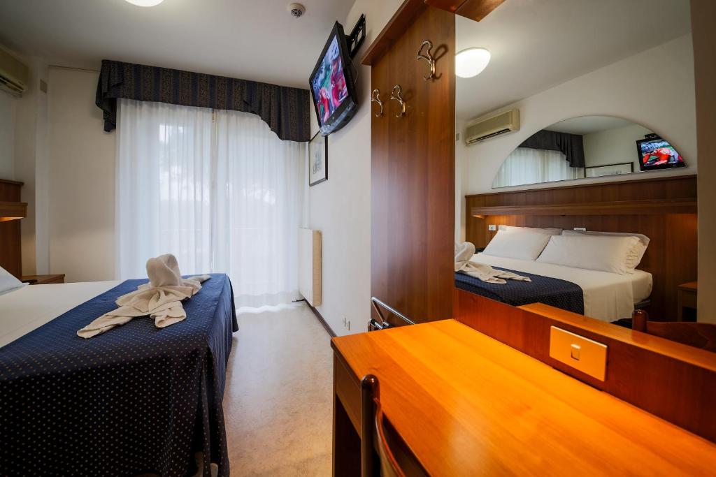 Postel nebo postele na pokoji v ubytování Hotel Vina De Mar