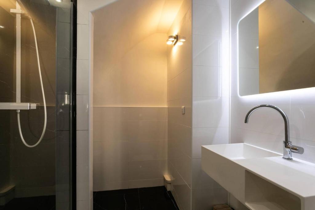 a bathroom with a sink and a shower at Hôtel Le Mistral in Marseille